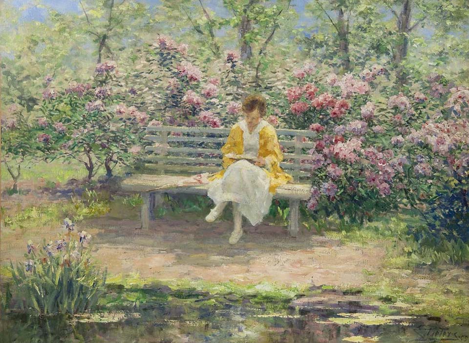 Woman reading in a garden on a beautiful may day